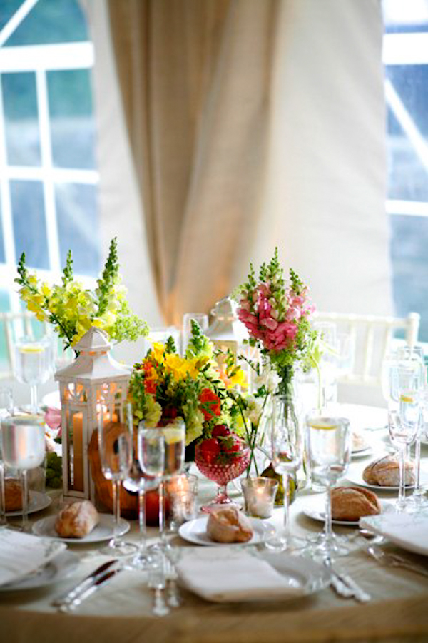 floral centerpiece and table setting in a tented reception site - charming Hudson Valley NY wedding photo by top New York wedding photographers Belathee Photography